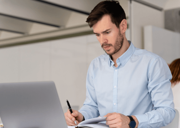 A marketing manager reviews a Haitian Creole brochure proof, using Haitian Creole Translation Services in Miami for business.