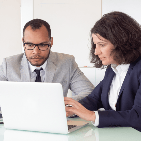Executives review a certified bilingual contract during a signing, using French Translation Services in Miami for business.
