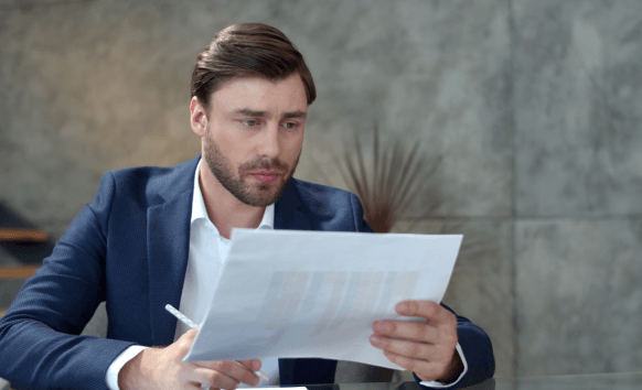 A translator checks a formatted document in an office, delivering French Translation Services in Miami for business.
