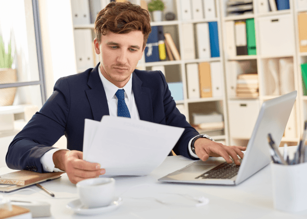 A translator checks legal terms on a laptop and uploads a certified file using Spanish Translation Services in Miami.